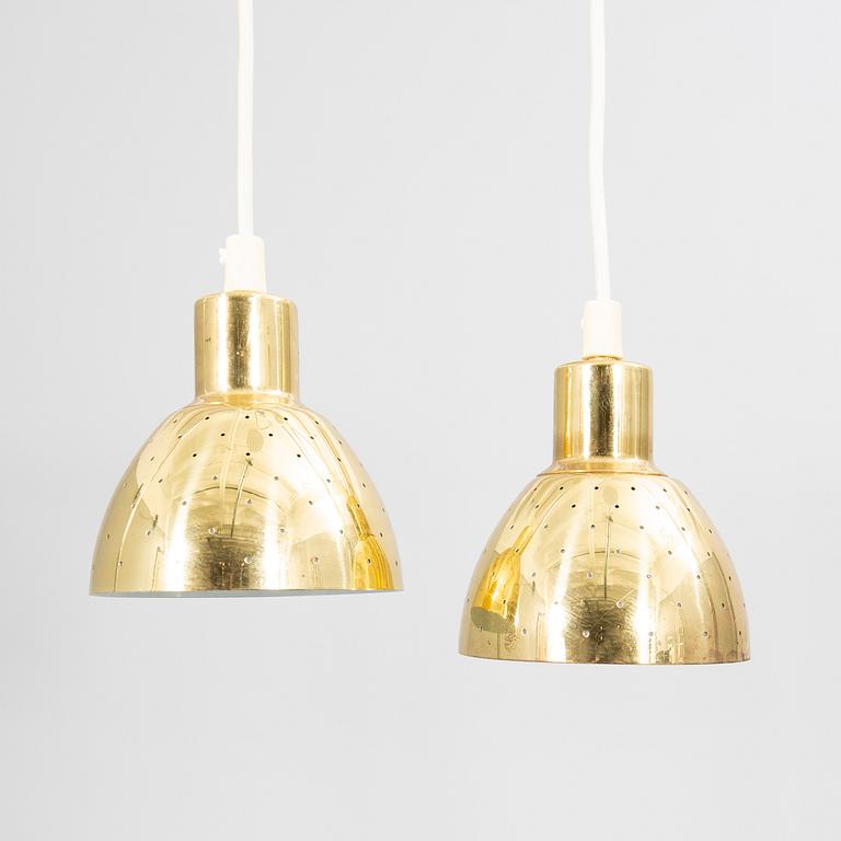 A pair of Hans-Agne Jakobsson brass ceiling pendants.