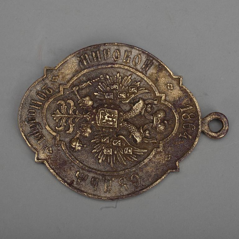 MÄRKE/BRICKA, förnicklad brons, Ryssland daterad 20 November 1864.