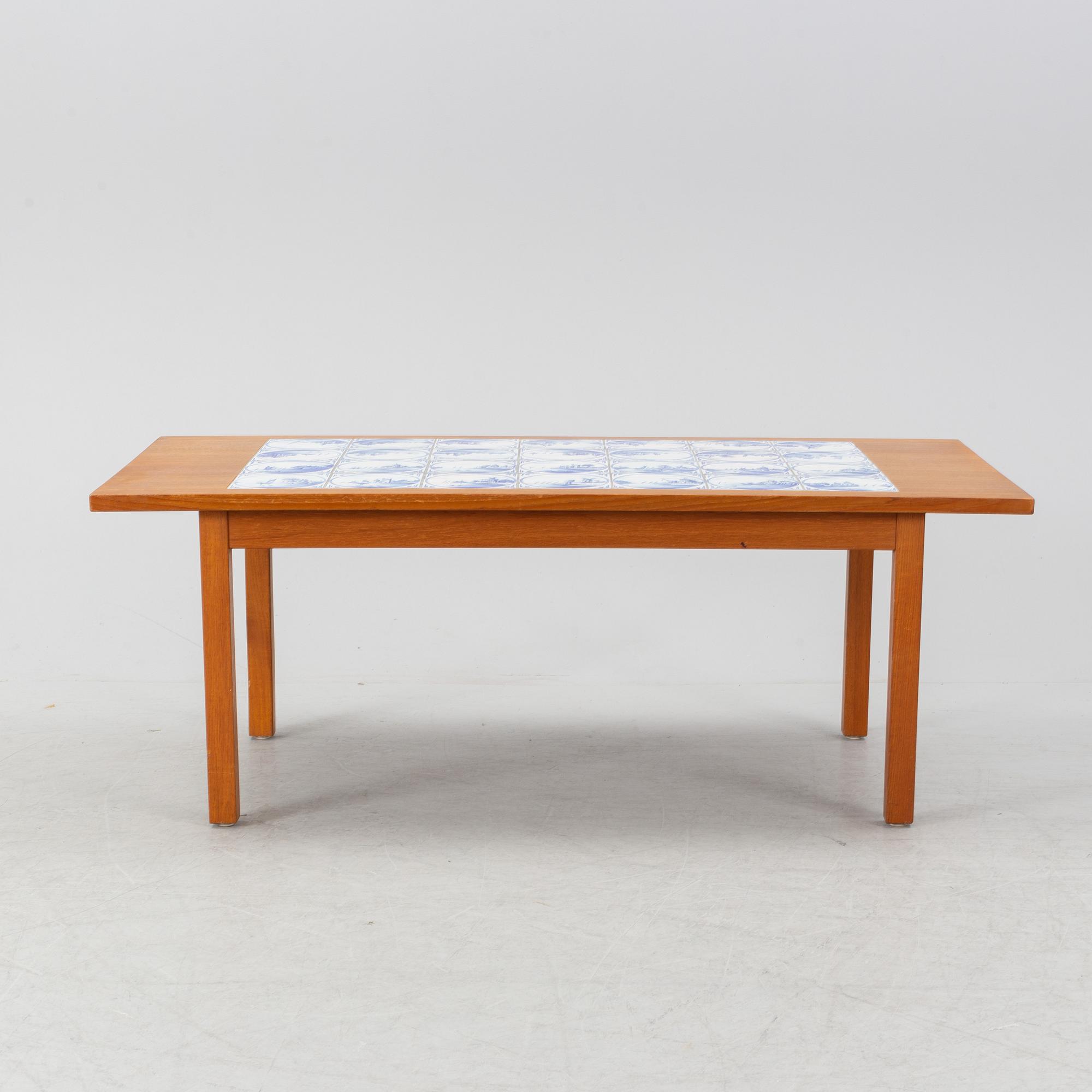 A teak coffee table with inlaid tiles. Second half of the 20th Century.