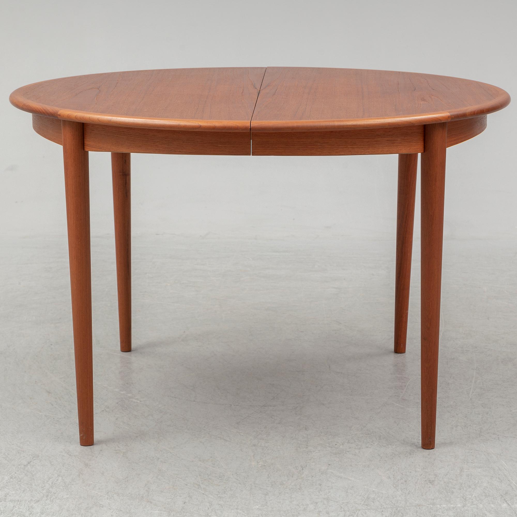 A 1960s teak veneered dining table.