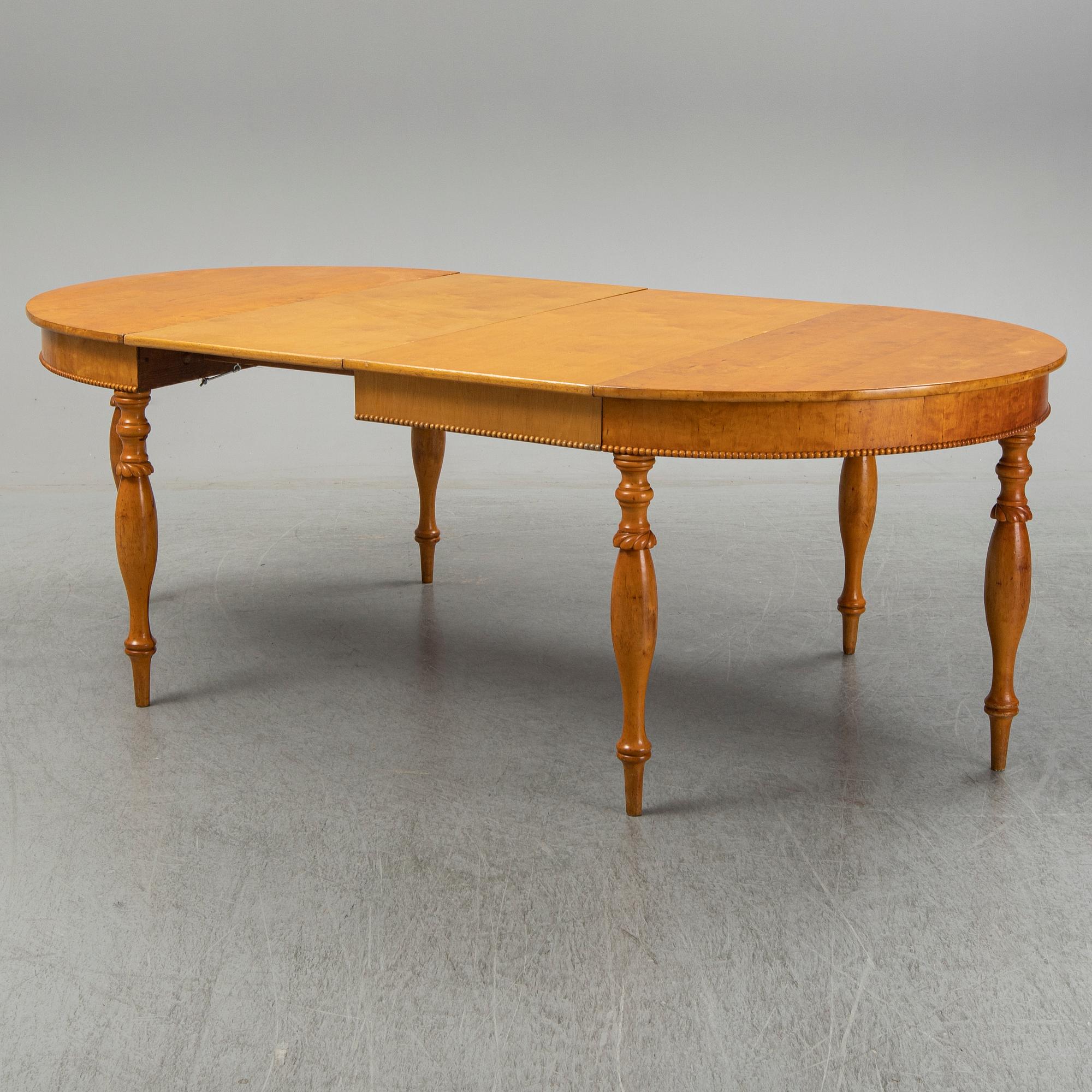 A mid 19th century birch dining table.
