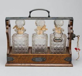 A EARLY 20TH CENTURY TANTALUS 'THE TANTALUS'.