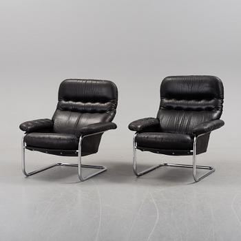 A pair of leather upholstered easy chairs from Dux, late 20th Century.