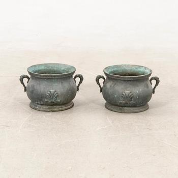 Outer casings/urns, a pair from the first half of the 20th century, cast iron.