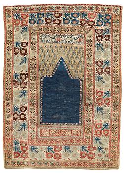 310. A RUG, an antique Gördes (Ghiordes) prayer rug, second half of the 18th century, ca 167-170 x 120-123 cm.