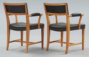 A pair of Josef Frank walnut and black leather armchairs, Svenskt Tenn, model 695.