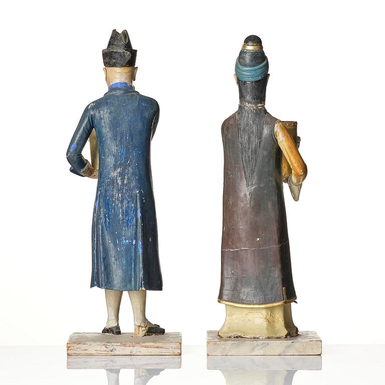 A pair of Chinoiserie figures of a Parsi tradesman and his wife, Qing dynasty, Canton, 19th century.