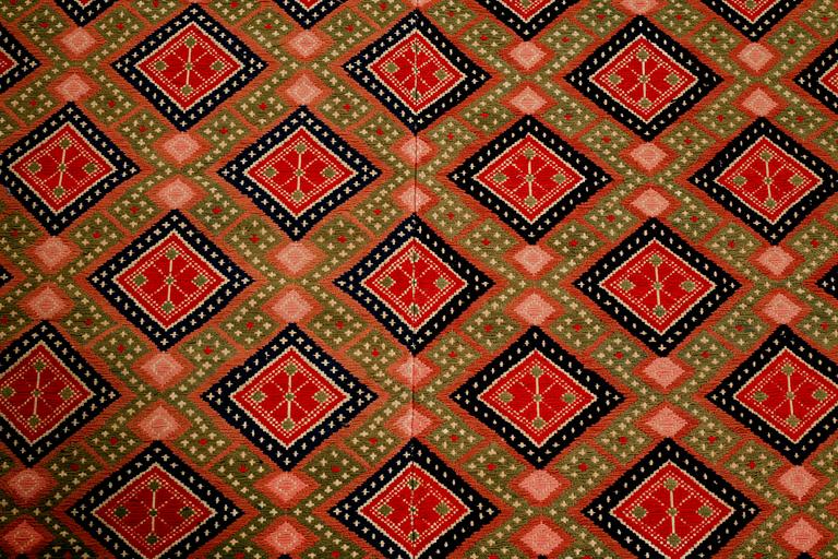 A wall textile, signed, around the year 1900, 208 x 130 cm.