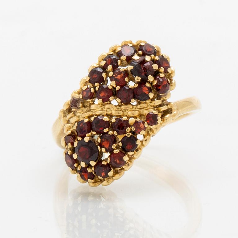 An 18K gold ring with garnets.