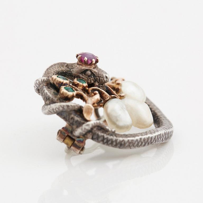 A Karl Rothmüller, Art Nouveau serpent brooch, circa 1900, with a ruby, emeralds and probably natural saltwater pearls.