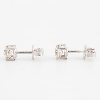 A pair of brilliant cut diamond earrings.