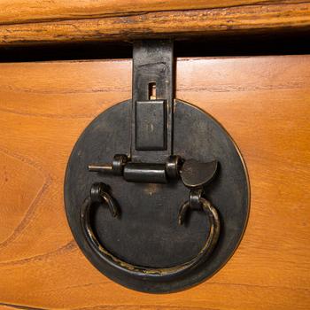 A Chinese elmwood sideboard, from around the turn of the century 1900.