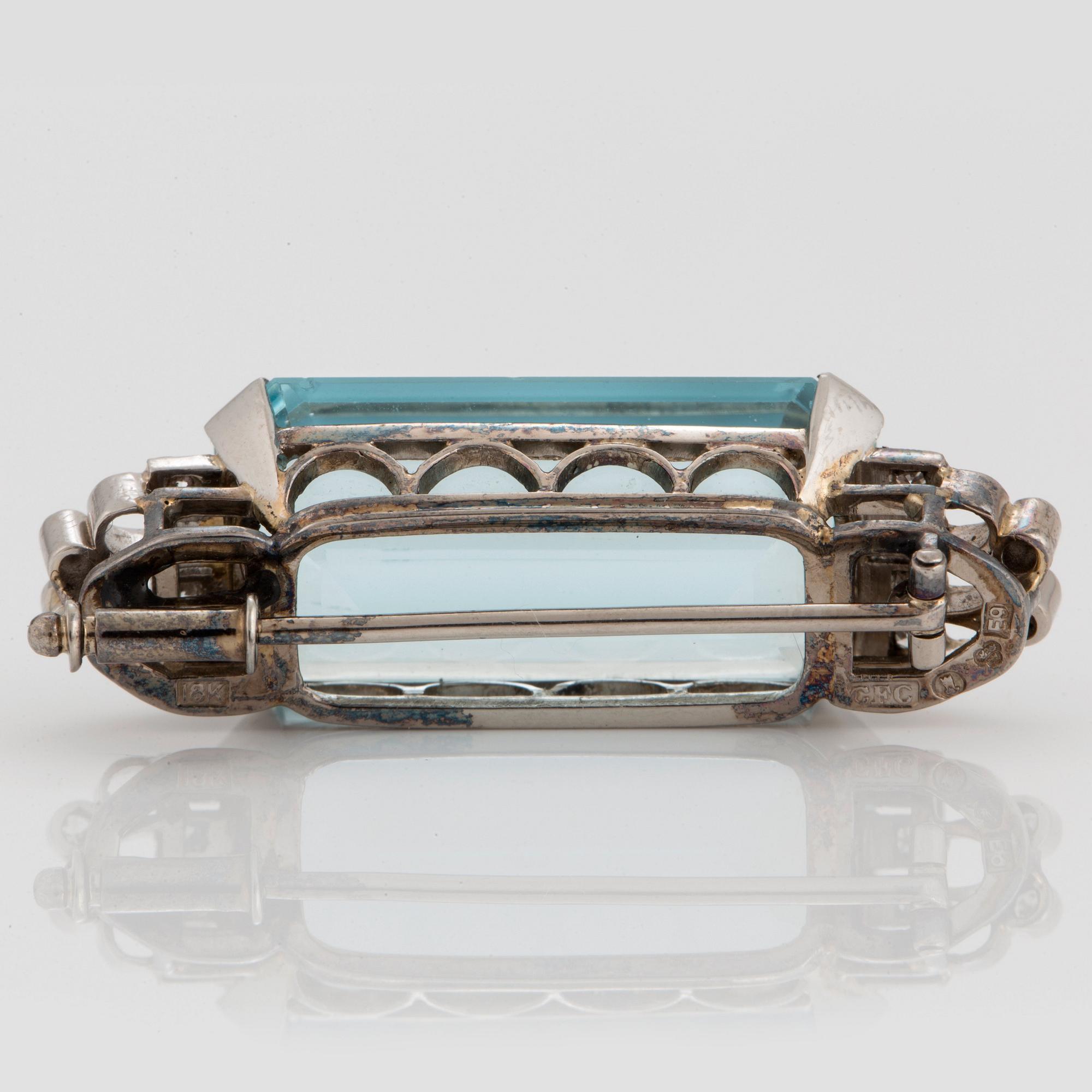 A CF Carlman brooch in 18K white gold set with a faceted aquamarine and eight-cut diamonds.