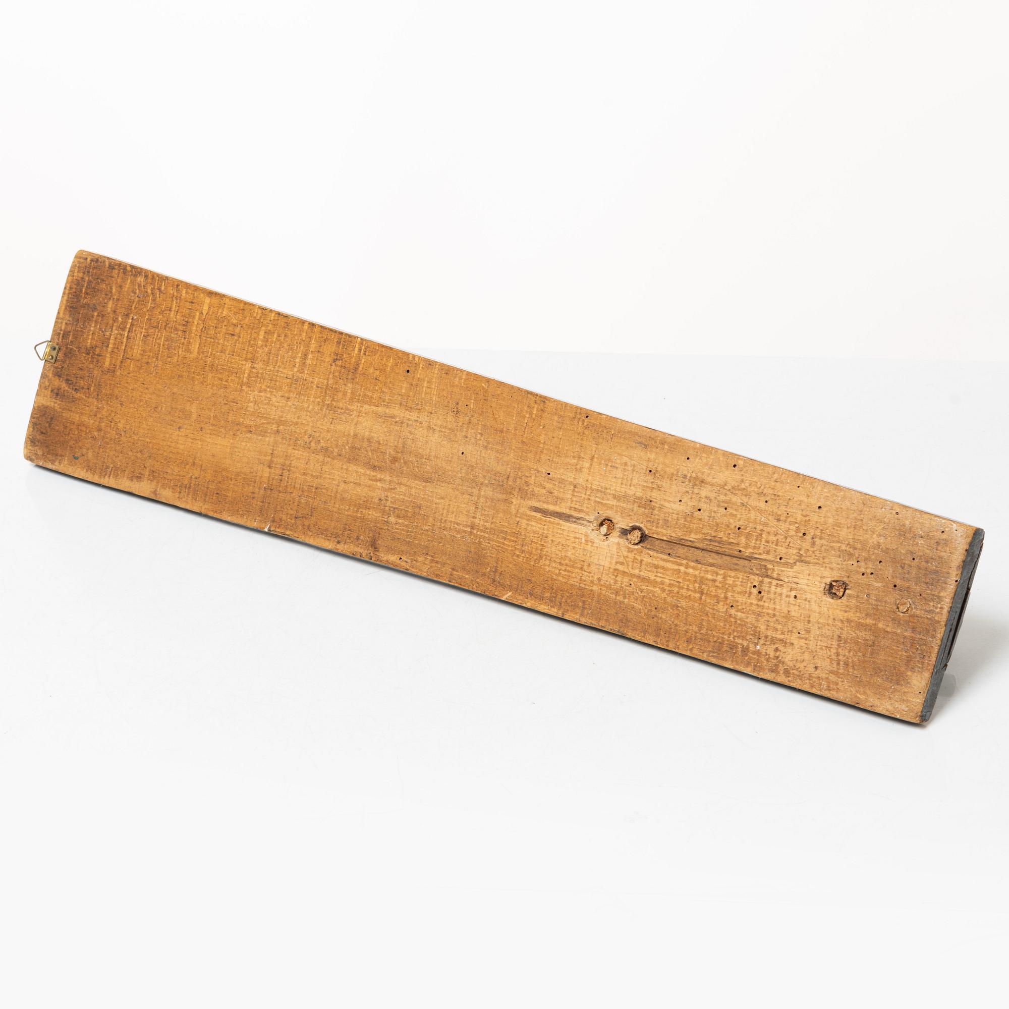 A painted wooden mangle board, dated 1831.