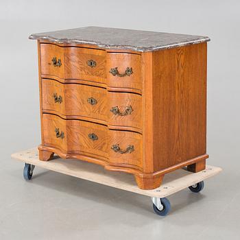 A baroque style chest of drawers, around the year 1900.