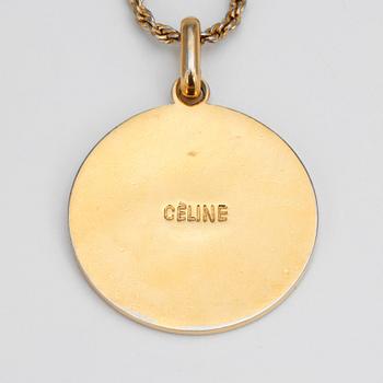 CELINE, a gold colored chain with pendant.