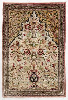 An Qum silk rug, c.. 80 x 53 cm.