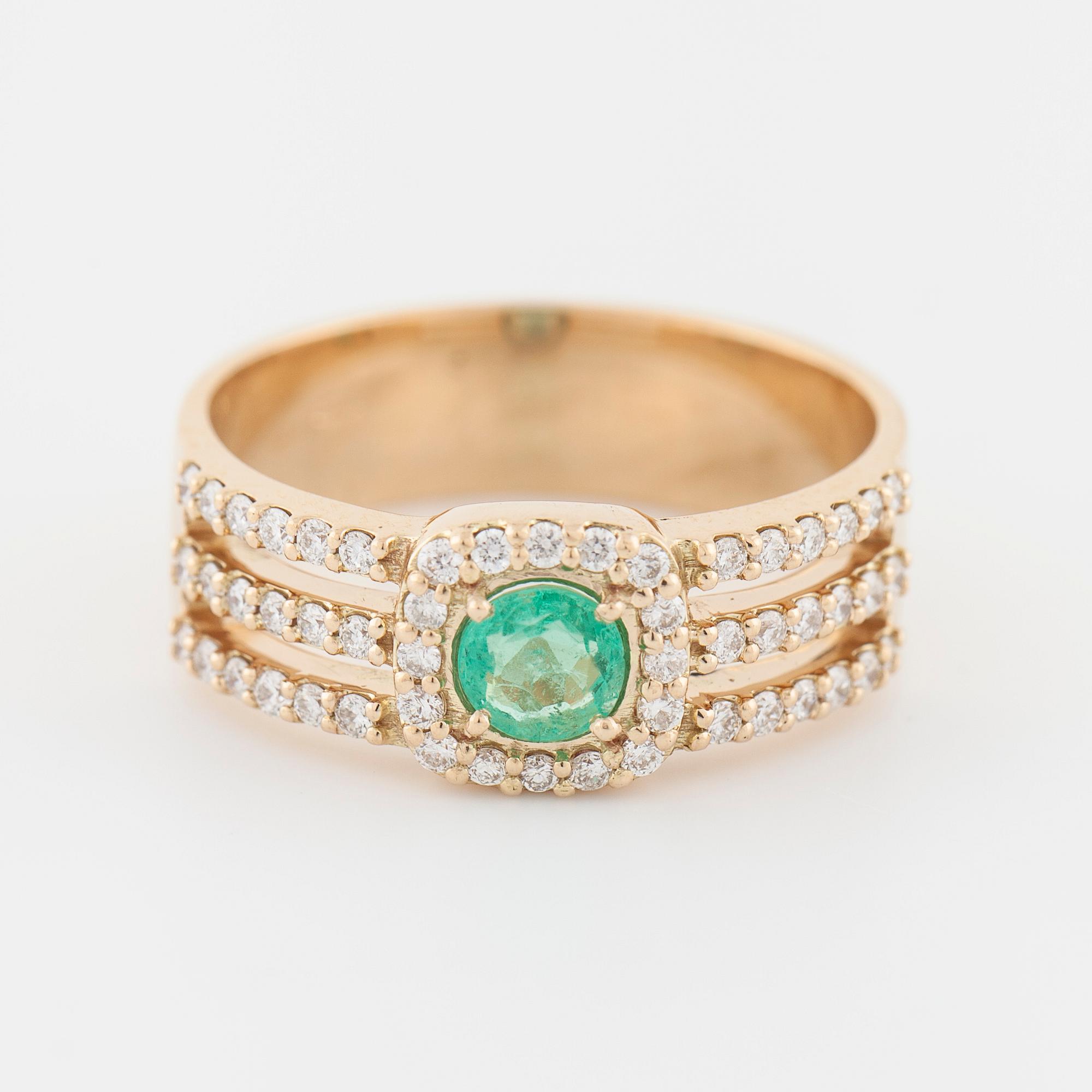 An emerald and brilliant cut diamond ring.