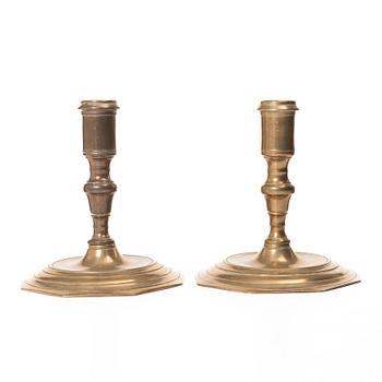 A pair of Swedish late baroque brass candlesticks, mid 18th century.