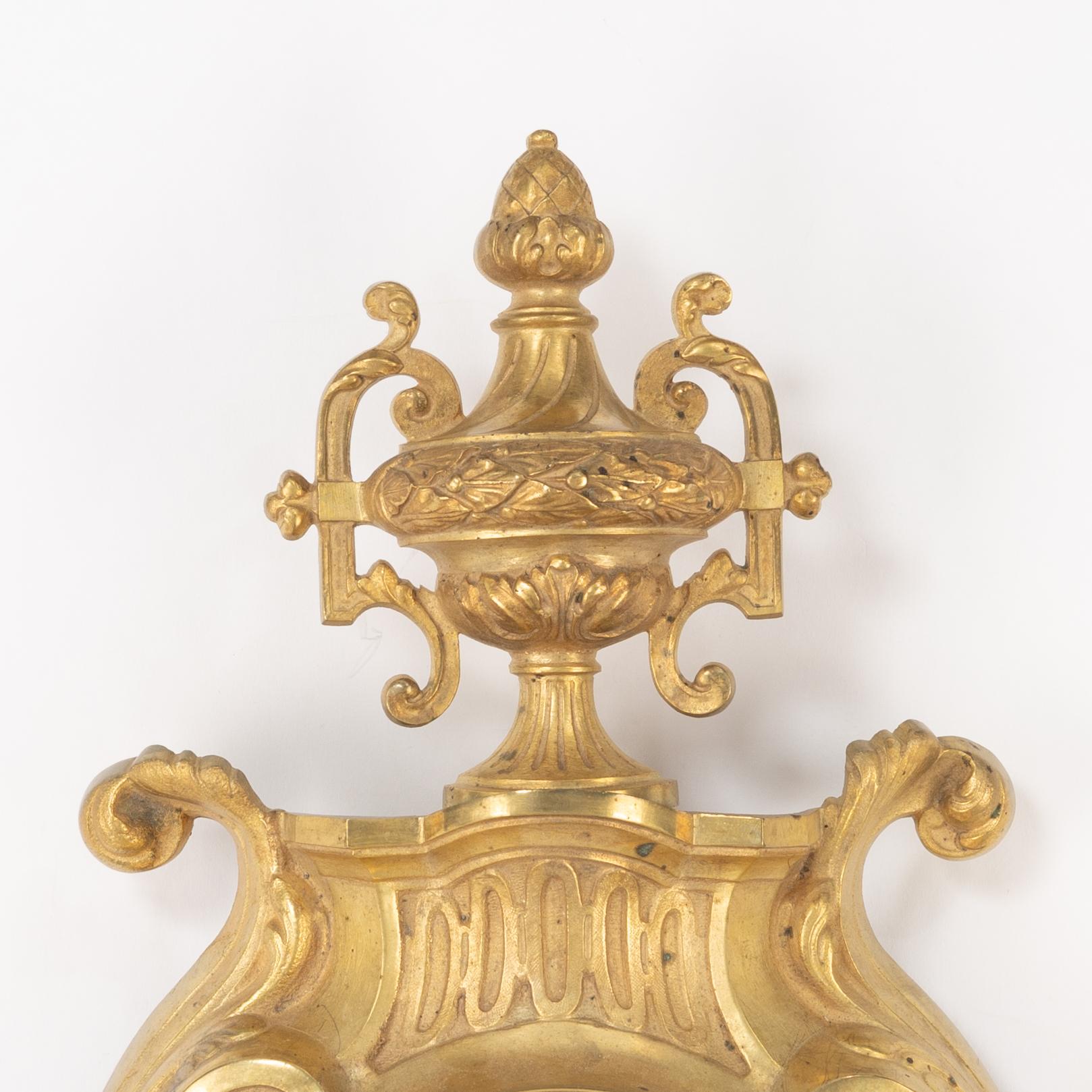 A bronze wall clock, Louis XVI style, France, circa 1900.