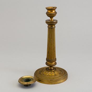 A pair of French gilt bronze Empire candlesticks, first half of the 19th Century.