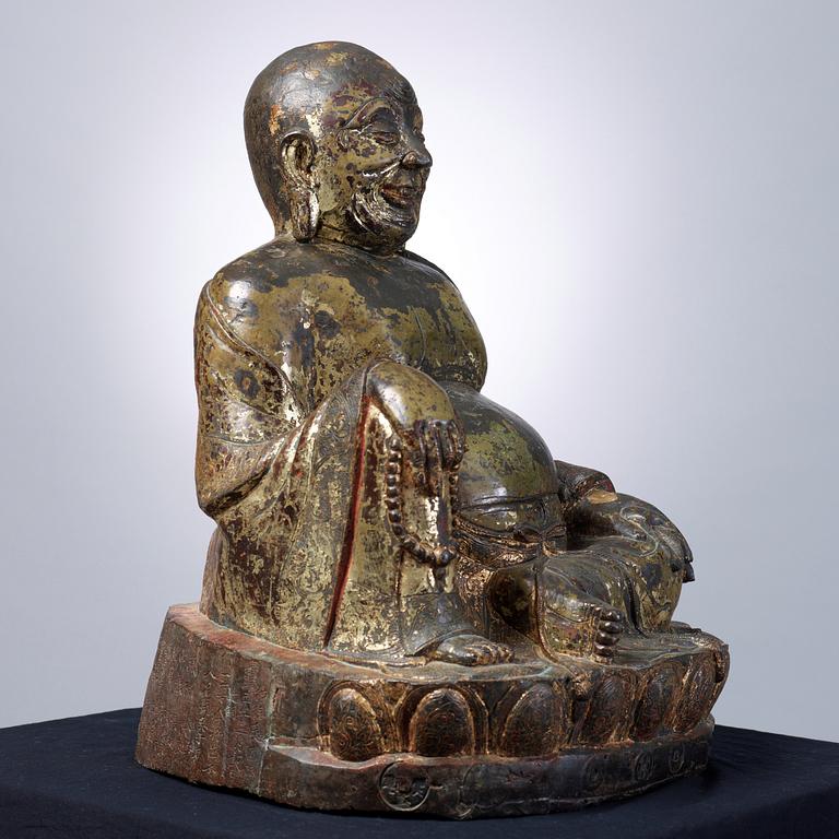 A large seated bronze figure of Budai, Ming Dynasty, dated to the fifth year of Jiajing (1526).