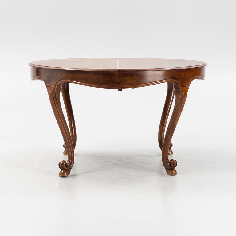 A mahogany rococo style dining table, 19th Century.