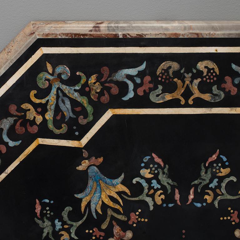 An oktagonal stone table top with inlays, Italy, about 1900.