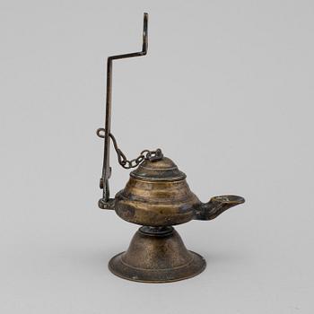 An 18th century bronze oil lamp.