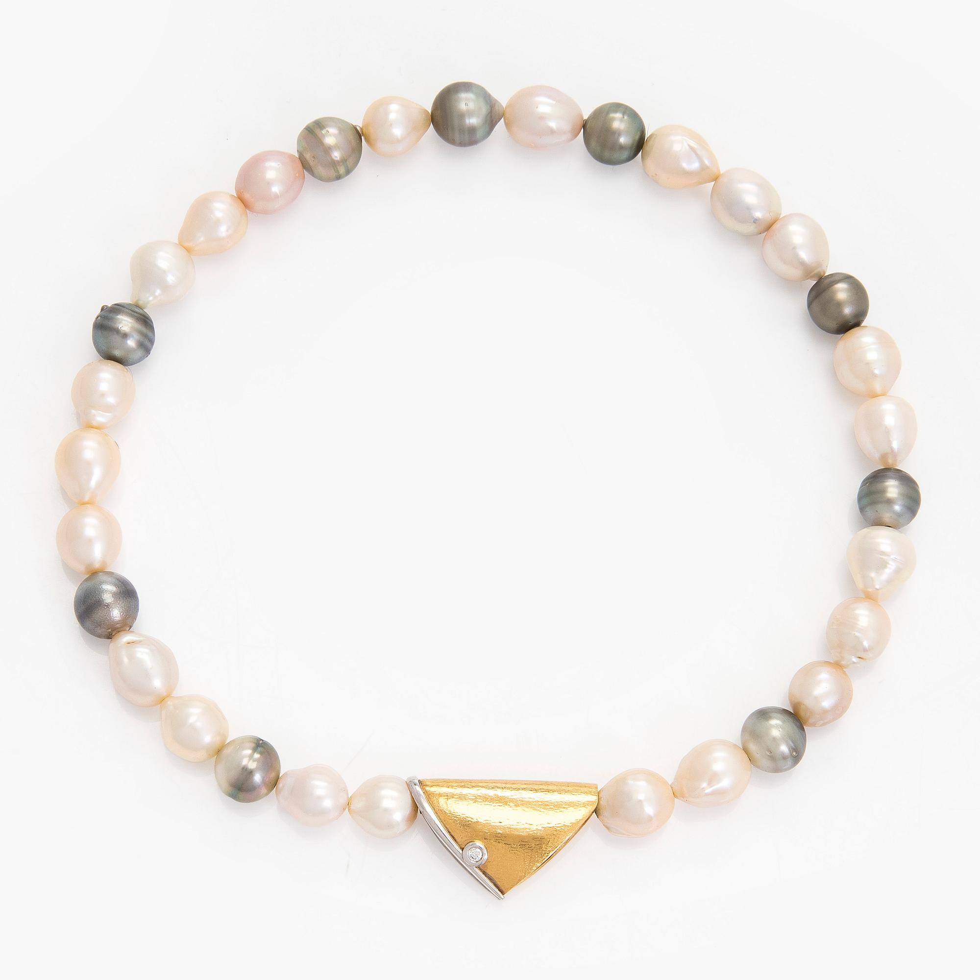 Ole Lynggaard, A cultured pearl necklace, clasp in 18K gold with a round brilliant-cut diamond.