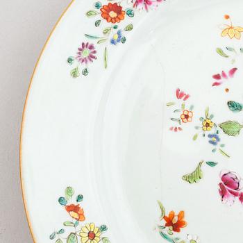 A set of two blue and white serving dishes, and two famille rose dinner plates, Qing dynasty, Qianlong (1736-95).