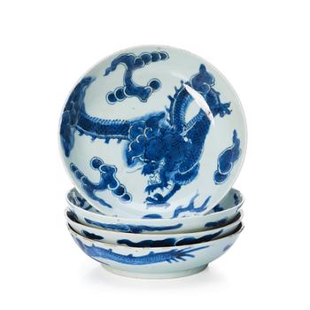 1123. A set of four blue and white dragon dishes, Qing dynasty, 18th Century.