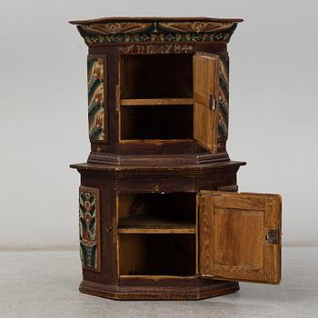 A Swedish corner cabinet dated 1784.