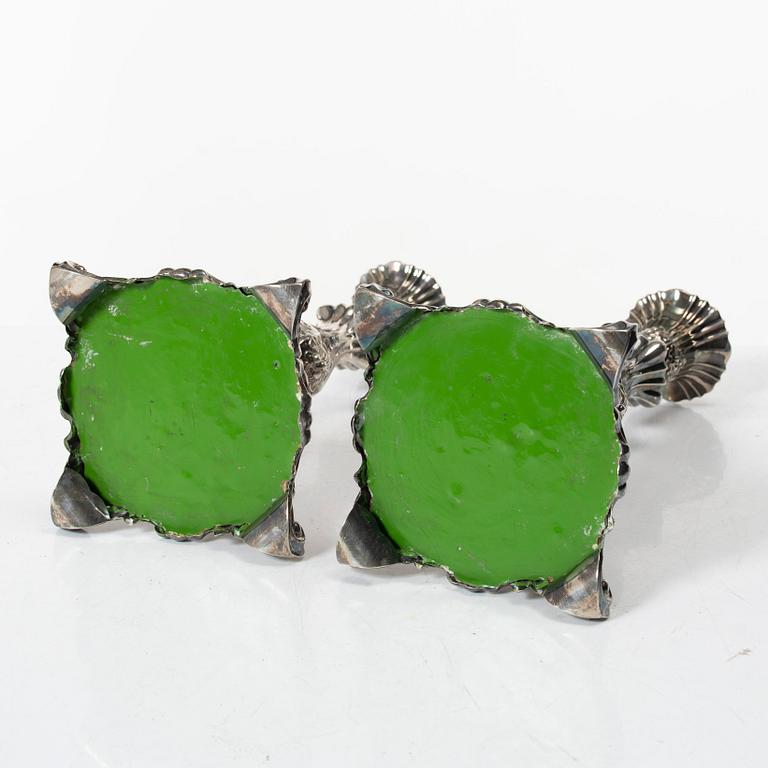 A pair of rococo-style silver candle sticks, early 20th century.