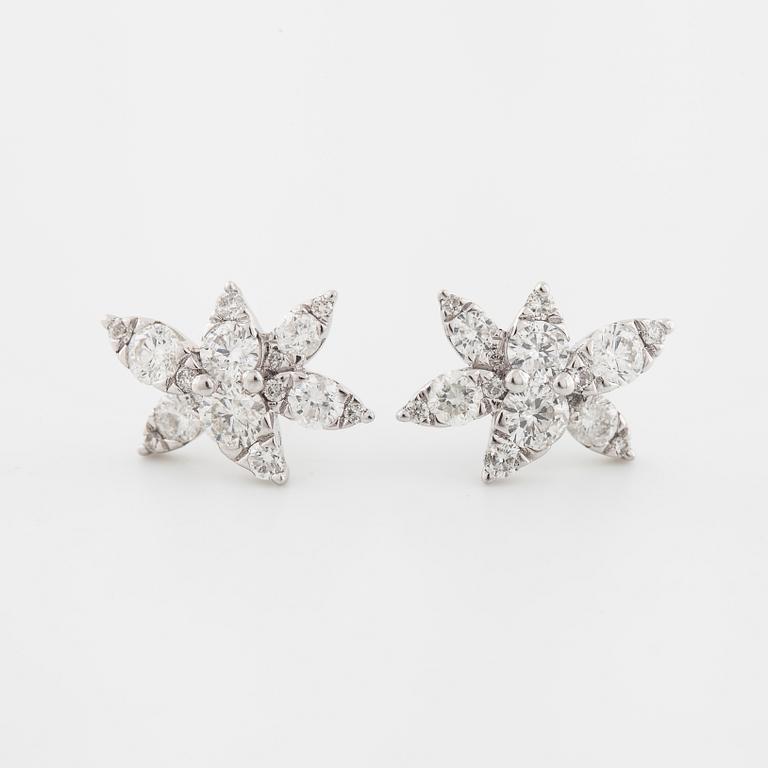 A pair of brilliant cut diamond earrings.