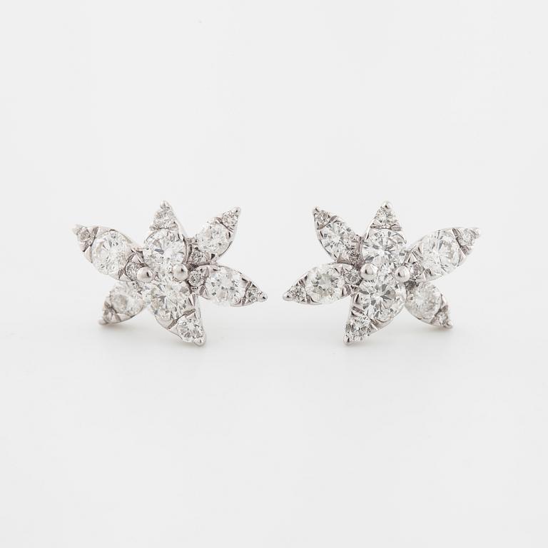 A pair of brilliant cut diamond earrings.