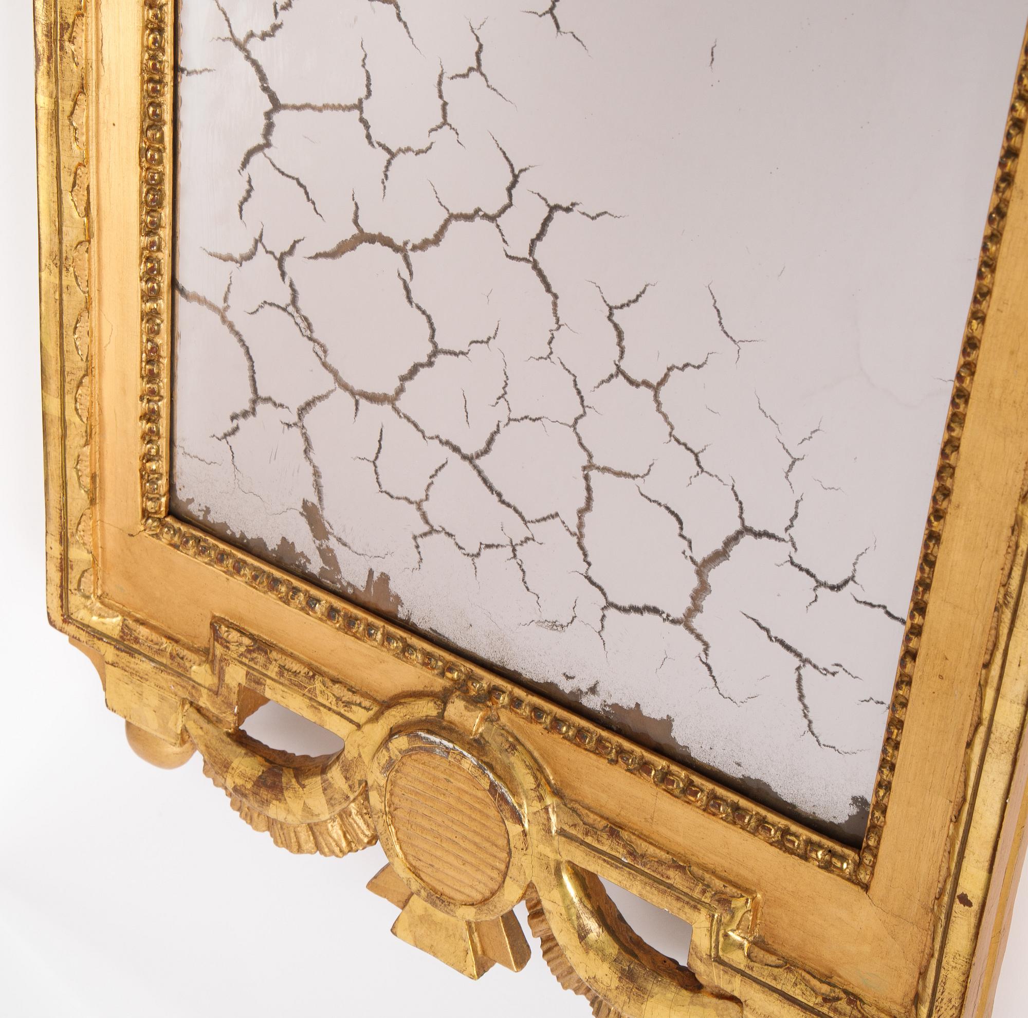 A gustavian giltwood and parcel-gilt mirror by Johan Åkerblad (master 1758-1799).