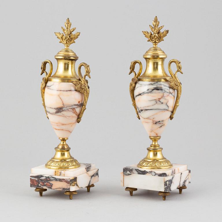 A pair of gilt brass and quartzite decorative urns, circa 1900.