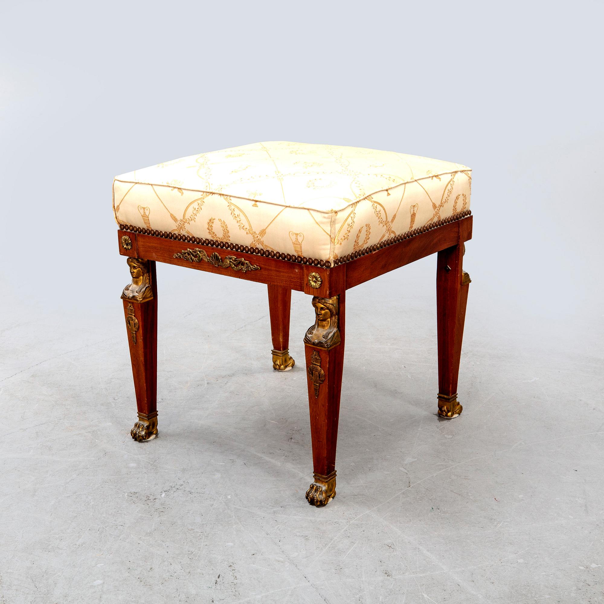 An Empire style mahogany stool around 1900.