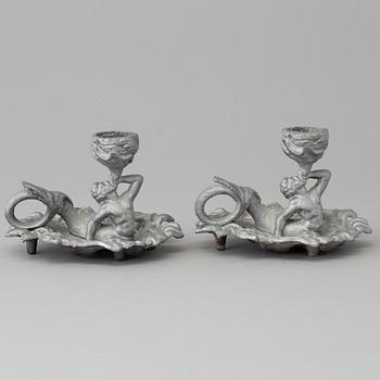 A pair of cast iron candlesticks, marked Verlag bei, A. Meves, Berlin, late 20th century.