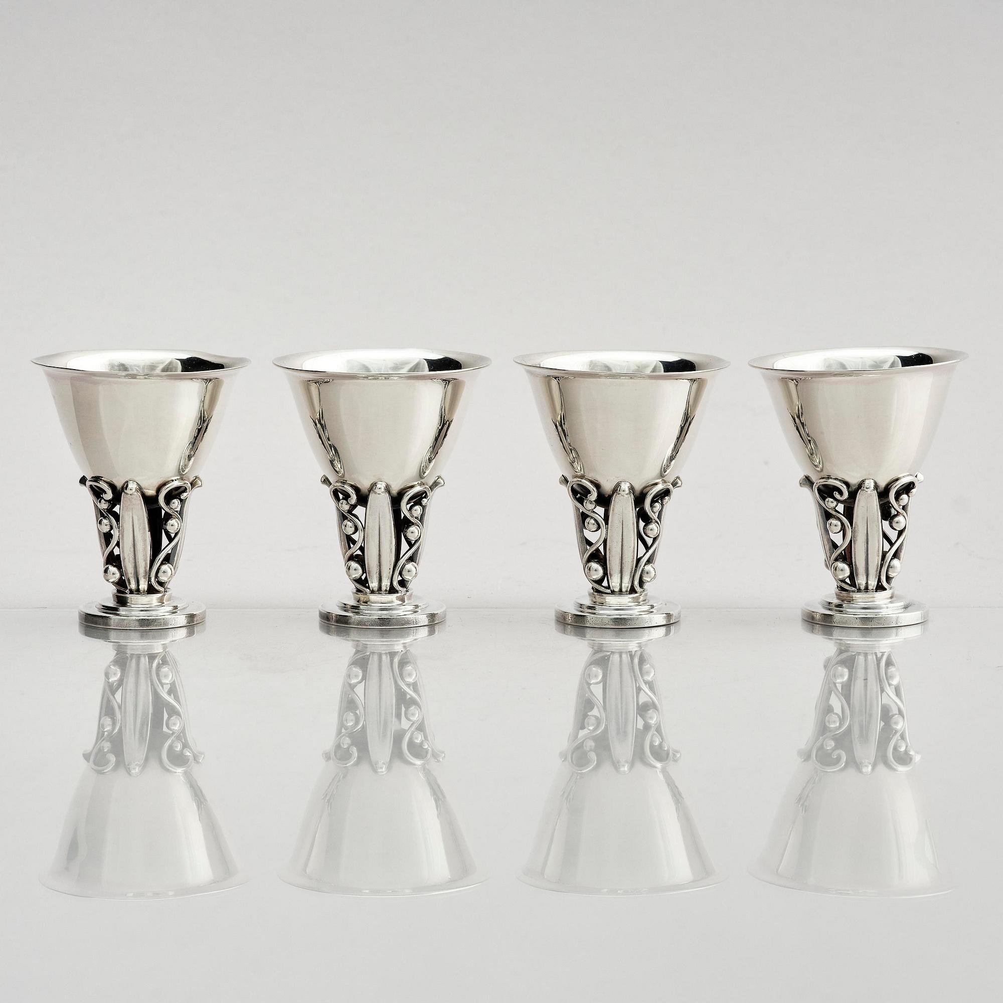 Evald Nielsen, four sterling silver beakers/cups on a foot, Denmark 20th century.