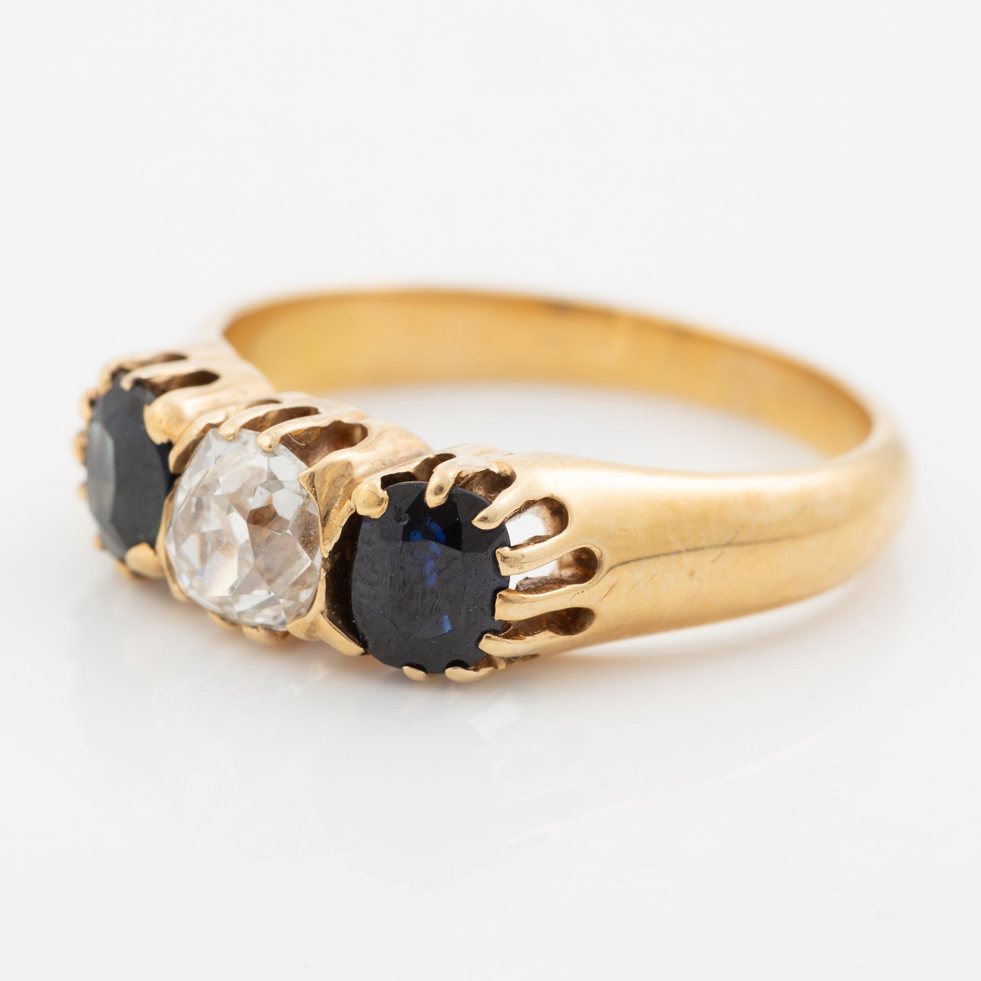 Ring 14K gold with an old-cut diamond and two blue stones.