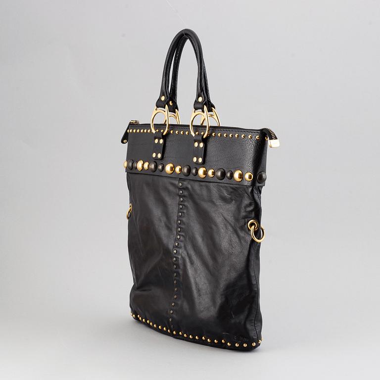 Gucci, a black leather handbag.