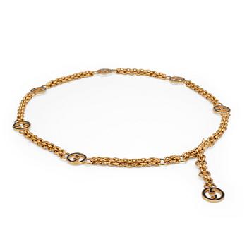 611. GUCCI, a gold colored mongrammed chain.