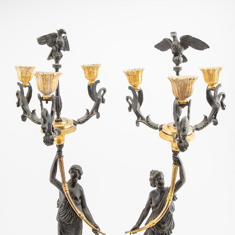 A pair (nearly) of Empire style candelabras later part of the 19th century.