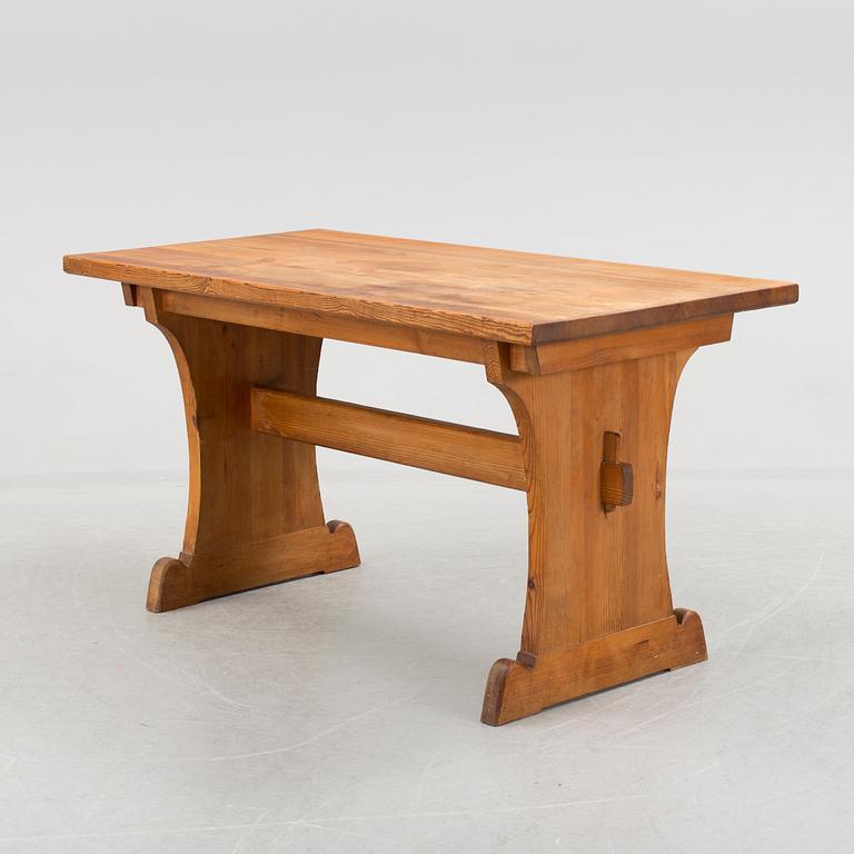 A solid pine table attributed to Axel Einar Hjort.