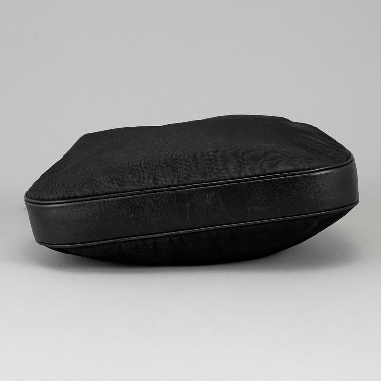 GUCCI, a canvas handbag.