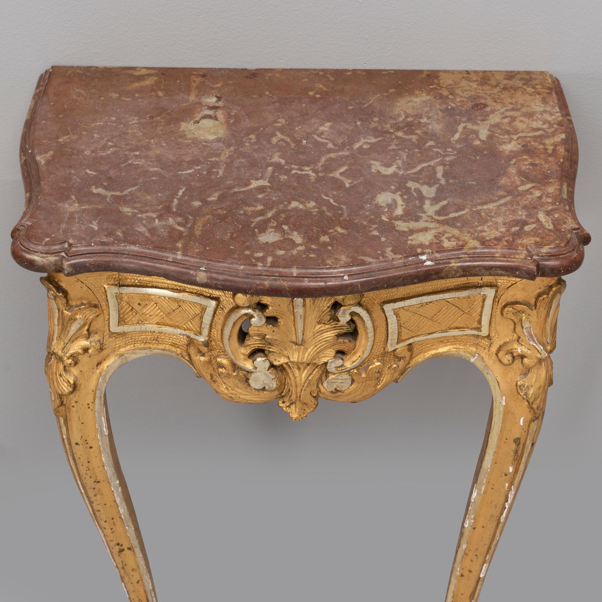 A rococo console table with a stone top, second half of the 18th century.