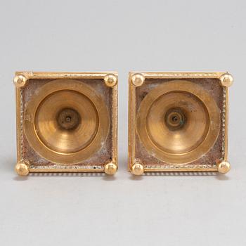 A pair of model 38 brass candlesticks from Gusums Bruk, first half of the 20th century.