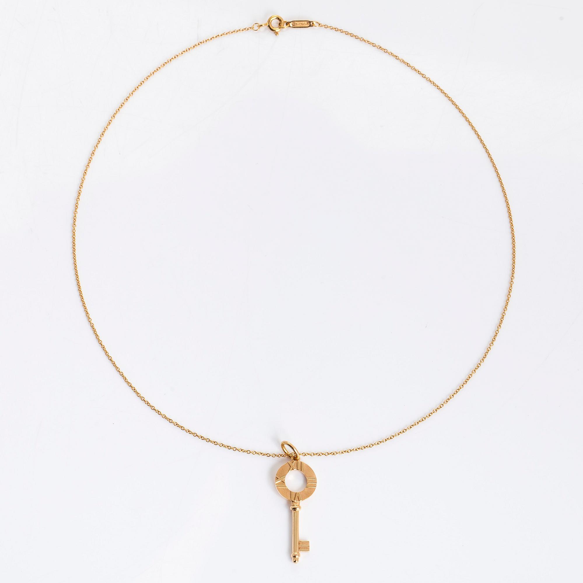 Tiffany & Co, an 18K gold 'Atlas Key' pendant with chain.